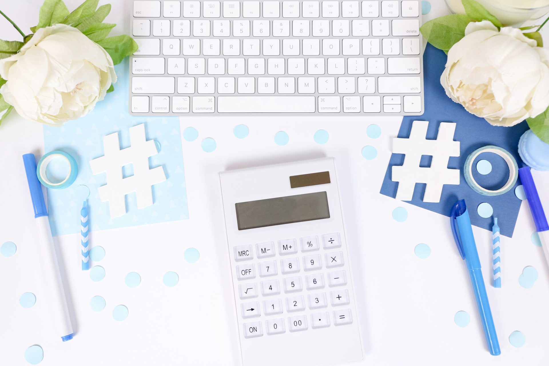 Calculator and hashtags on a decorative desk.